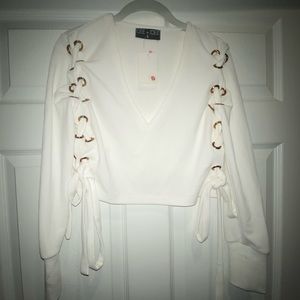 White crop top with gold accents